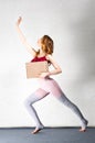 Young woman posing with a box in her hands. Package for yoga classes