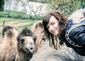 Young woman posing with camel, blue filter Royalty Free Stock Photo