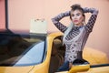 Young woman posing near the supercar, outdoors portrait Royalty Free Stock Photo