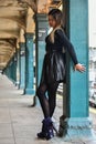 Young woman posing outside in NYC subway station.