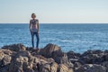 Young woman posing on rocks by the Black sea Royalty Free Stock Photo