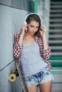 Young woman posing with skateboard, summer, urban, outdoor