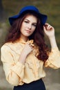 Young woman posing in the street in hat Royalty Free Stock Photo