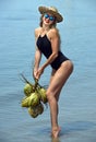 Young woman posing at the tropical beach with coconuts Royalty Free Stock Photo