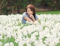 Young woman posing with white daffodils Royalty Free Stock Photo