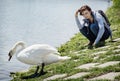 Young woman posing with white swan on the lakeside Royalty Free Stock Photo