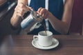 Young woman pouring coffee in diner Royalty Free Stock Photo