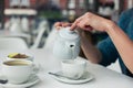 Young woman pouring a cup of tea Royalty Free Stock Photo