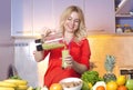 Young woman pouring freshly made smoothie