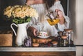 Young woman pouring green tea from pot into cup Royalty Free Stock Photo