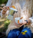 A young woman is pouring herself a cup of coffee Royalty Free Stock Photo