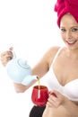 Young Woman Pouring Tea from a Teapot After Shower Royalty Free Stock Photo