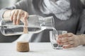 Young woman pouring water from bottle to glass Royalty Free Stock Photo