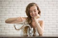 Young woman pouring water from jug into glass Royalty Free Stock Photo