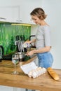 Young woman pours milk in stewpot for boiling Royalty Free Stock Photo