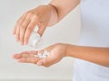 Young woman pours out medicine, capsule or pill into her hand. H Royalty Free Stock Photo