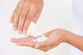 A young woman pours out medicine, capsule or pill into her hand.