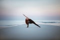 Summer yoga session on a beautiful golden beach of Maldives yoga tour, Extended Side Angle Pose Utthita Parsvakonasana Royalty Free Stock Photo