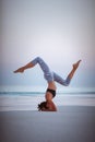 Summer yoga session on a beautiful golden beach of Maldives yoga tour, Salamba Sirsasana - supported headstand Royalty Free Stock Photo