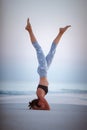 Summer yoga session on a beautiful golden beach of Maldives yoga tour, Salamba Sirsasana - supported headstand Royalty Free Stock Photo