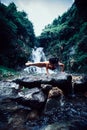 Woman practice yoga near waterfall in forest