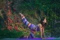 Young woman practice yoga outdoor colorful autumn background