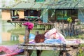 Young woman practice yoga outdoor spring day by the lake full body shot