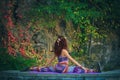 young woman practice yoga spaga pose outdoor colorful autumn background