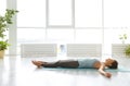 Young woman practicing corpse asana in yoga studio Royalty Free Stock Photo