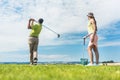 Young woman practicing the correct move during golf class