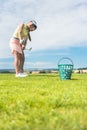 Young woman practicing the correct move during golf class with Royalty Free Stock Photo