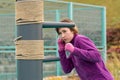 Young woman practicing martial arts alone on the sports ground with traditional dummies Royalty Free Stock Photo