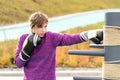 Young woman practicing martial arts alone on the sports ground with traditional dummies Royalty Free Stock Photo