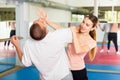 Young woman practicing palm strike with man in self defense training Royalty Free Stock Photo