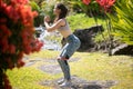 Young woman practicing squats in park. Fit girl exercising outdoors on summer day. Female fit back and buttocks. Royalty Free Stock Photo