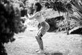 Young woman practicing squats in park. Fit girl exercising outdoors on summer day. Female fit back and buttocks. Royalty Free Stock Photo