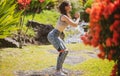 Young woman practicing squats in park. Fit girl exercising outdoors on summer day. Female fit back and buttocks. Royalty Free Stock Photo