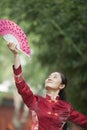 Young Woman Practicing Tai Ji With Traditional Chinese Fan Royalty Free Stock Photo