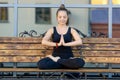 Young woman practicing vajra yoga sitting on bench