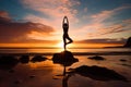 A young woman practicing yoga on the beach at sunset Royalty Free Stock Photo