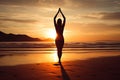 A young woman practicing yoga on the beach at sunset Royalty Free Stock Photo