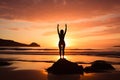 A young woman practicing yoga on the beach at sunset Royalty Free Stock Photo