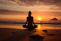 A young woman practicing yoga on the beach at sunset Royalty Free Stock Photo