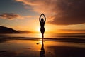 A young woman practicing yoga on the beach at sunset Royalty Free Stock Photo