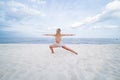 Young woman practicing yoga on the beach. Warrior pose Royalty Free Stock Photo