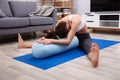 Young Woman Practicing Yoga With Bolster