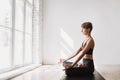 Young woman practicing yoga at class. Beautiful girl doing exercises at home. Royalty Free Stock Photo