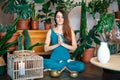 Young woman practicing yoga doing Ardha Padmasana exercise with namaste at home Royalty Free Stock Photo