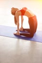 Young woman practicing yoga, doing Ushtrasana, Camel Pose