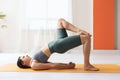 Young woman practicing yoga, doing variation of dvipada pithasana exercise, half bridge pose Royalty Free Stock Photo